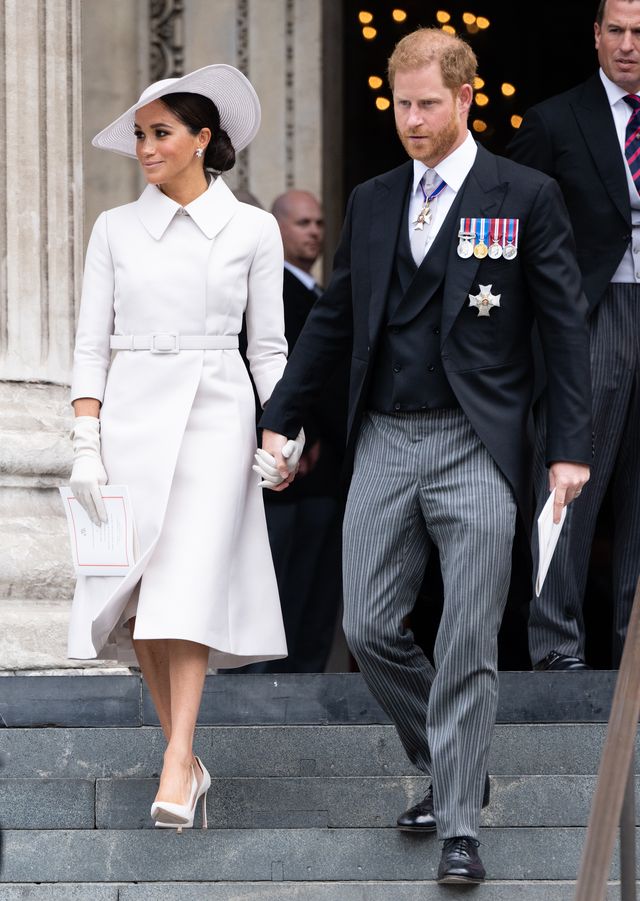 Meghan wears chic ivory coat dress as she arrives at Queen’s Jubilee service